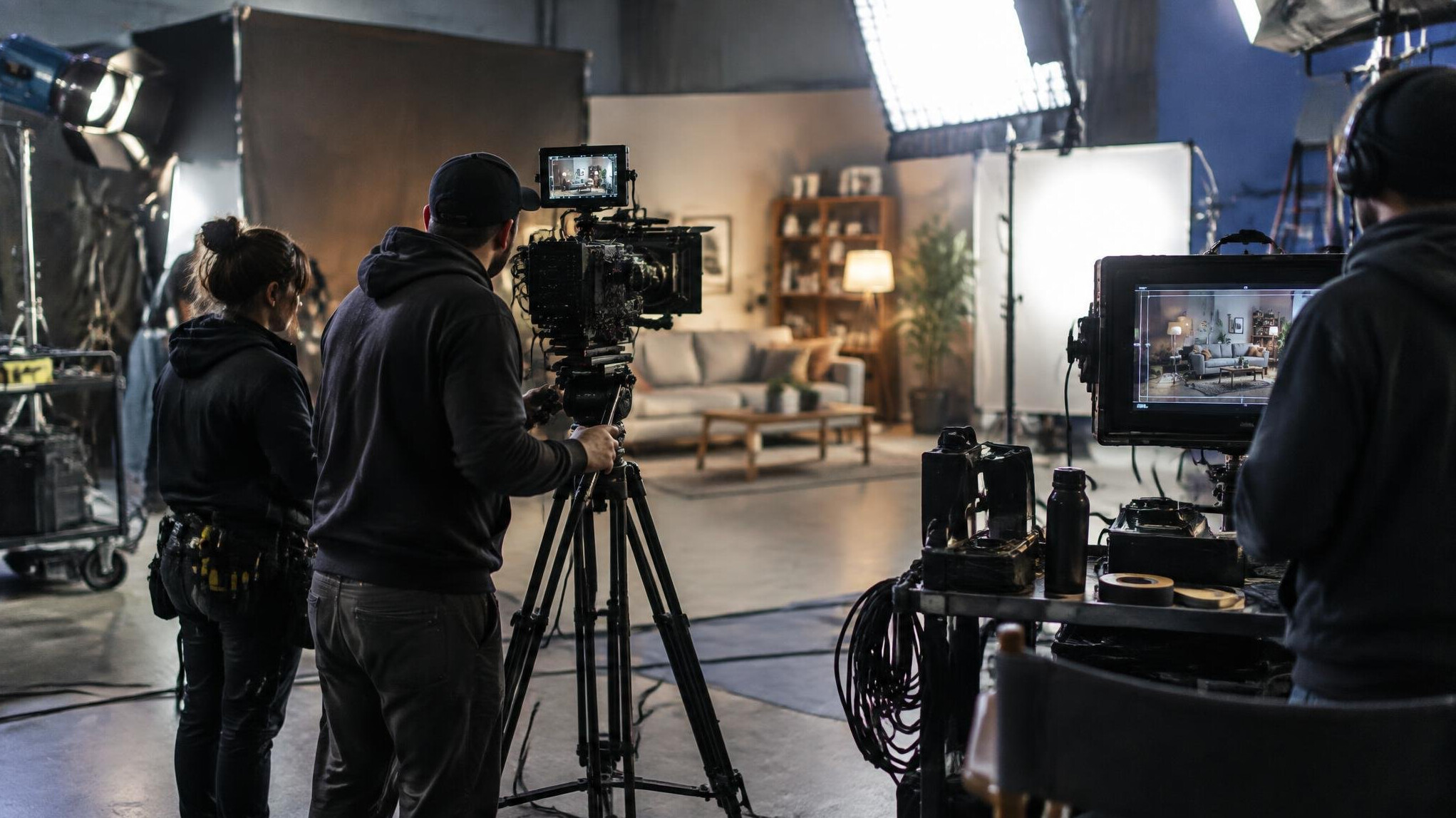 Film crew setting up a camera on a set